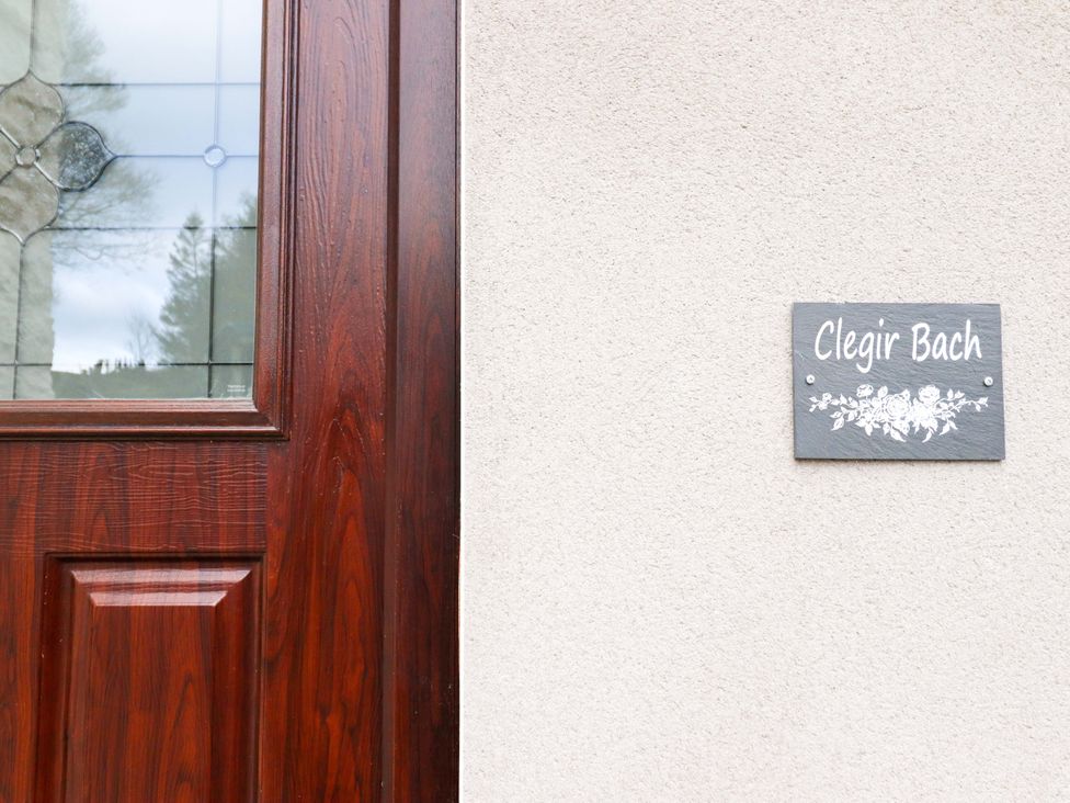 A door with a nameplate at Clegir Bach in Corwen