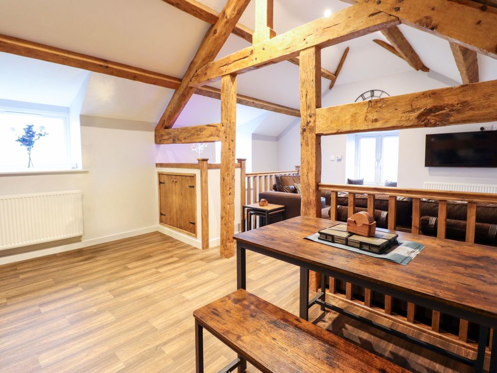 A living room with a table and sofa at Clegir Bach near Betws Gwerfil Goch