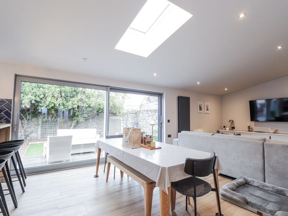 A living room with a table and chairs at Apple Tree Cottage in Cullen