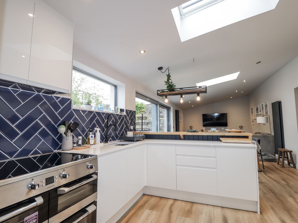 A kitchen with a stove and sink at Apple Tree Cottage in Cullen