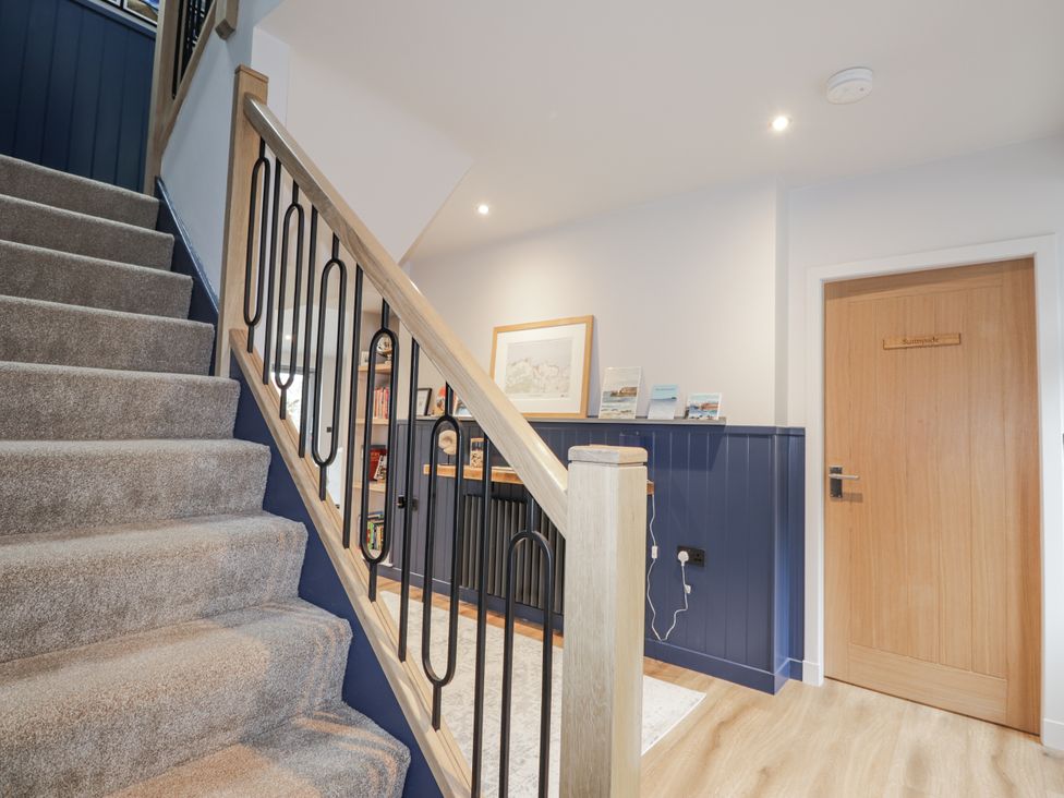 A hallway with stairs and a door at Apple Tree Cottage in Cullen
