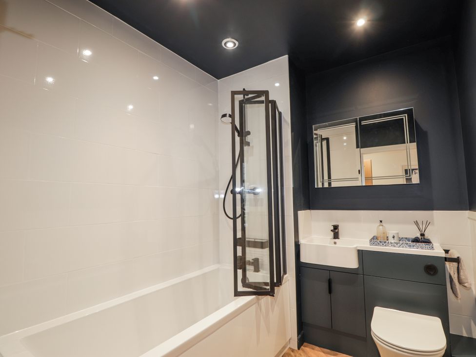 A bathroom with a bathtub and shower at Apple Tree Cottage in Cullen