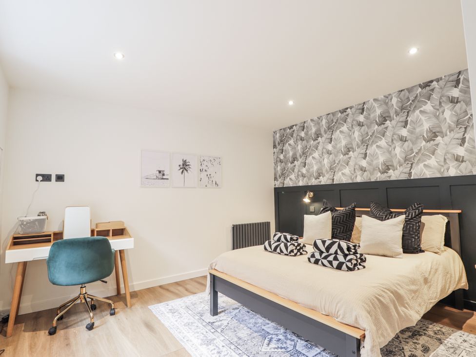 A bedroom with a bed and desk at Apple Tree Cottage in Cullen