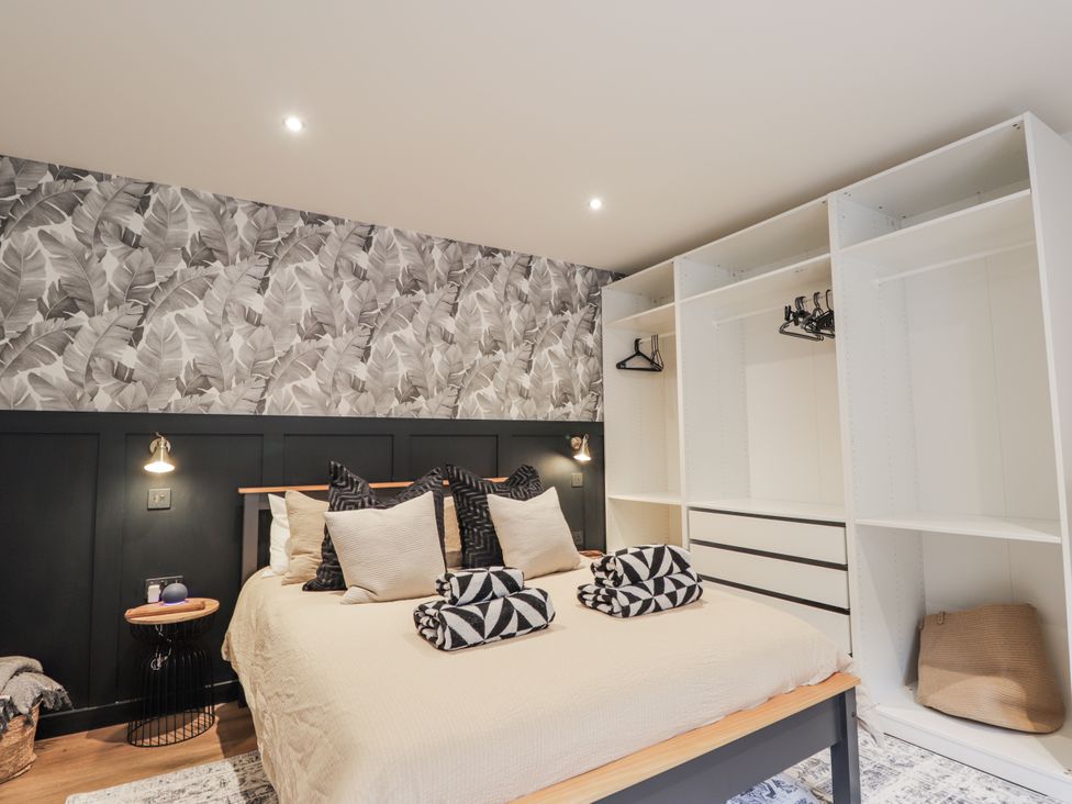 A bedroom with a bed and wardrobe at Apple Tree Cottage in Cullen