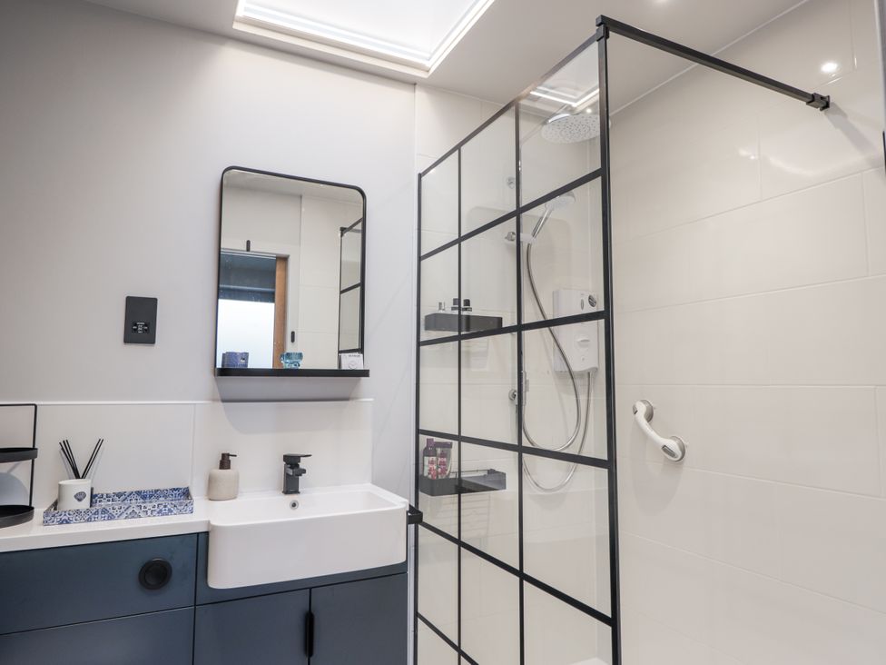 A bathroom with a shower and sink at Apple Tree Cottage in Cullen