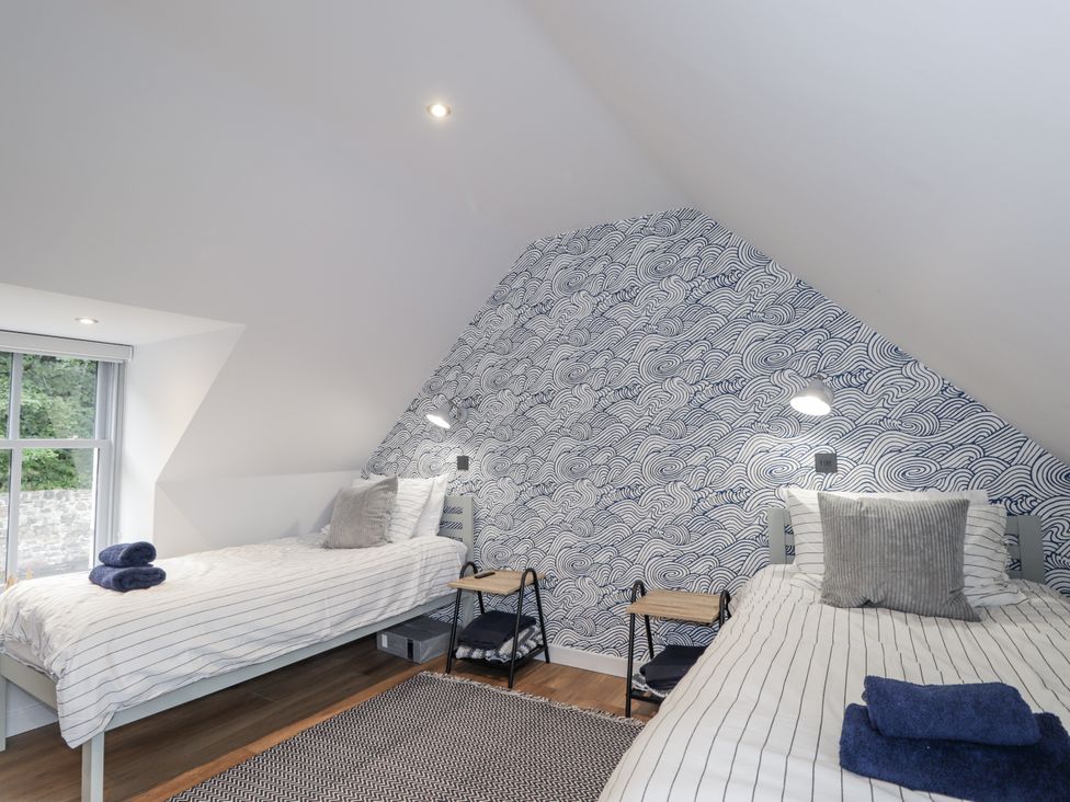 A bedroom with two single beds at Apple Tree Cottage in Cullen