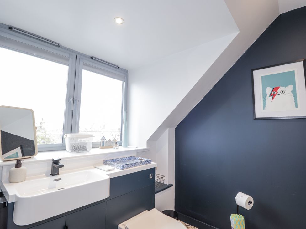 A bathroom with a sink and toilet at Apple Tree Cottage in Cullen
