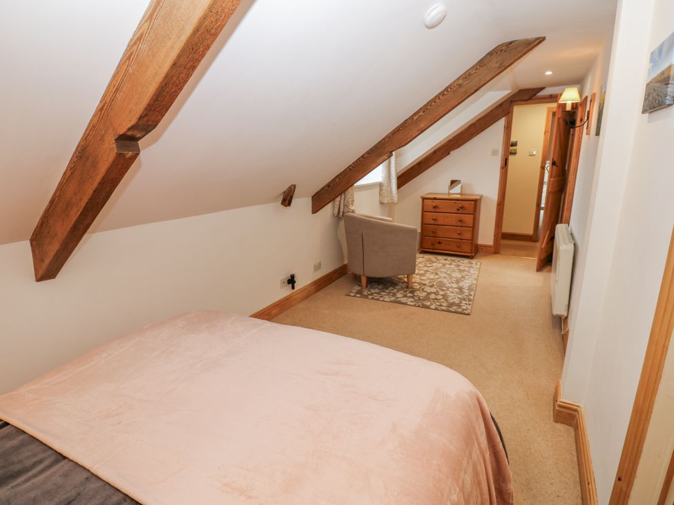A bedroom with a bed and furniture at 1 Mill Cottage known as Old Mill 1 Askrigg near West Burton