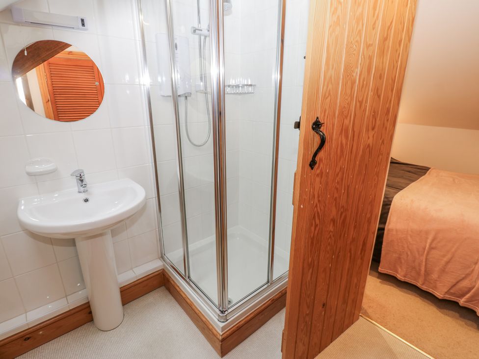 A bathroom with a shower and sink at 1 Mill Cottage (known as Old Mill 1) Askrigg near West Burton