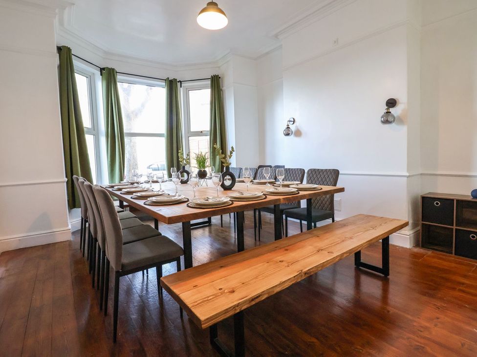 A dining room with a table set for dinner at Mariners Lee