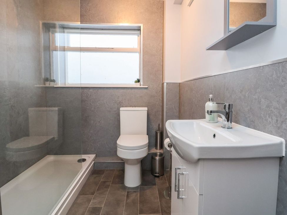 A bathroom with a toilet, sink and shower at Mariners Lee