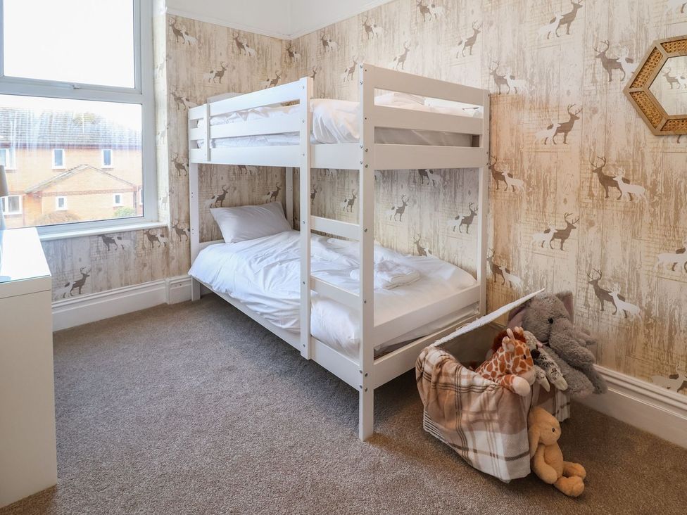 A bedroom with a bunk bed and stuffed animals at Mariners Lee
