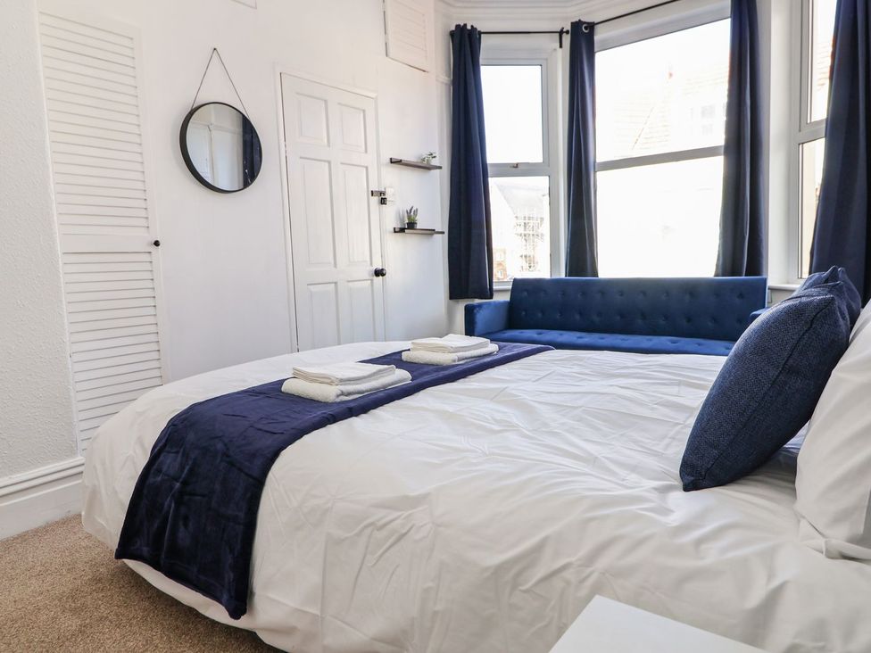 A bedroom with a bed and a sofa at Mariners Lee