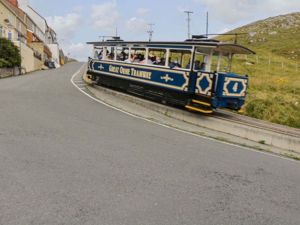 A tram traveling on a curved road at Mariners Lee in Llandudno