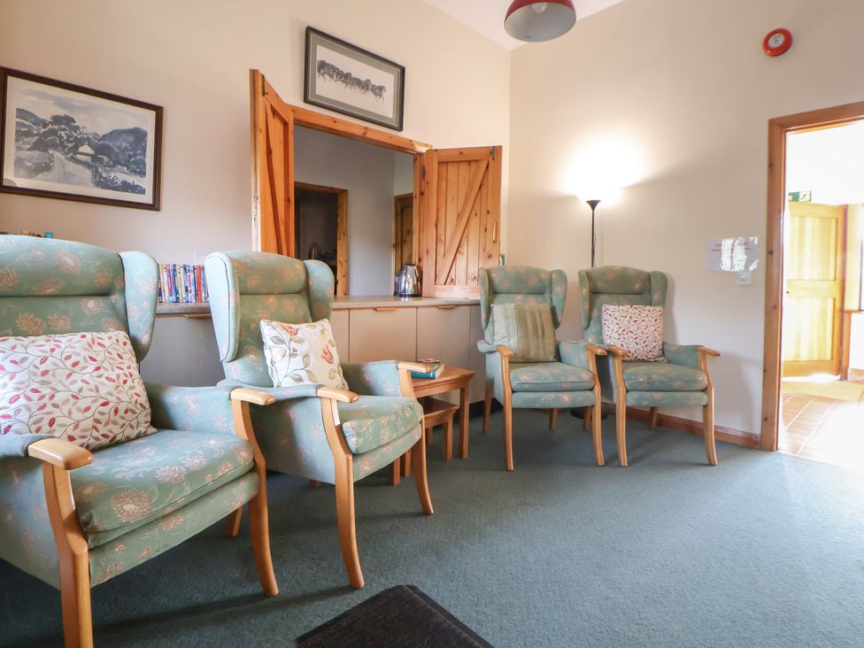 A snug with armchairs and a table at Clwyd Special Riding Centre 