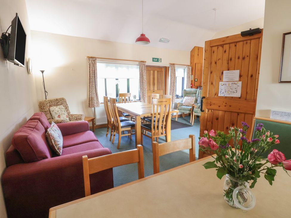 A dining room with a table and chairs at Clwyd Special Riding Centre