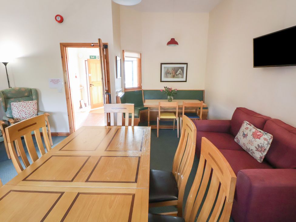 A common room with tables and chairs at Clwyd Special Riding Centre