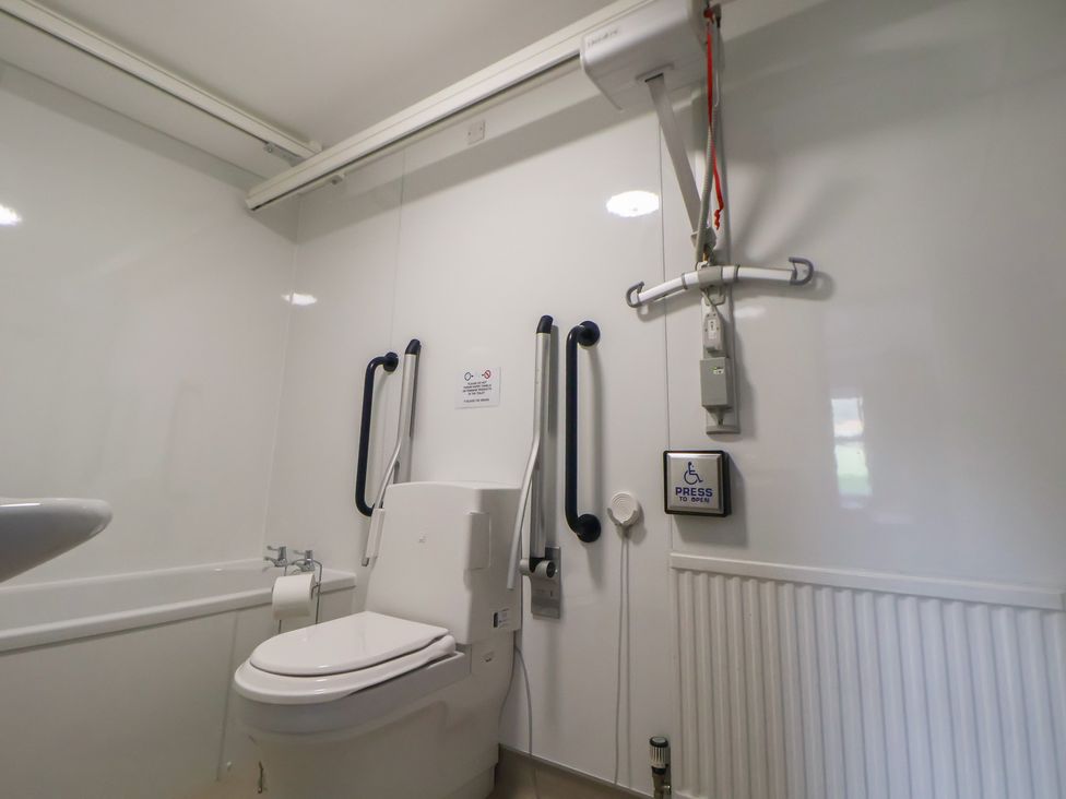 A bathroom with a toilet and sink at Clwyd Special Riding Centre 
