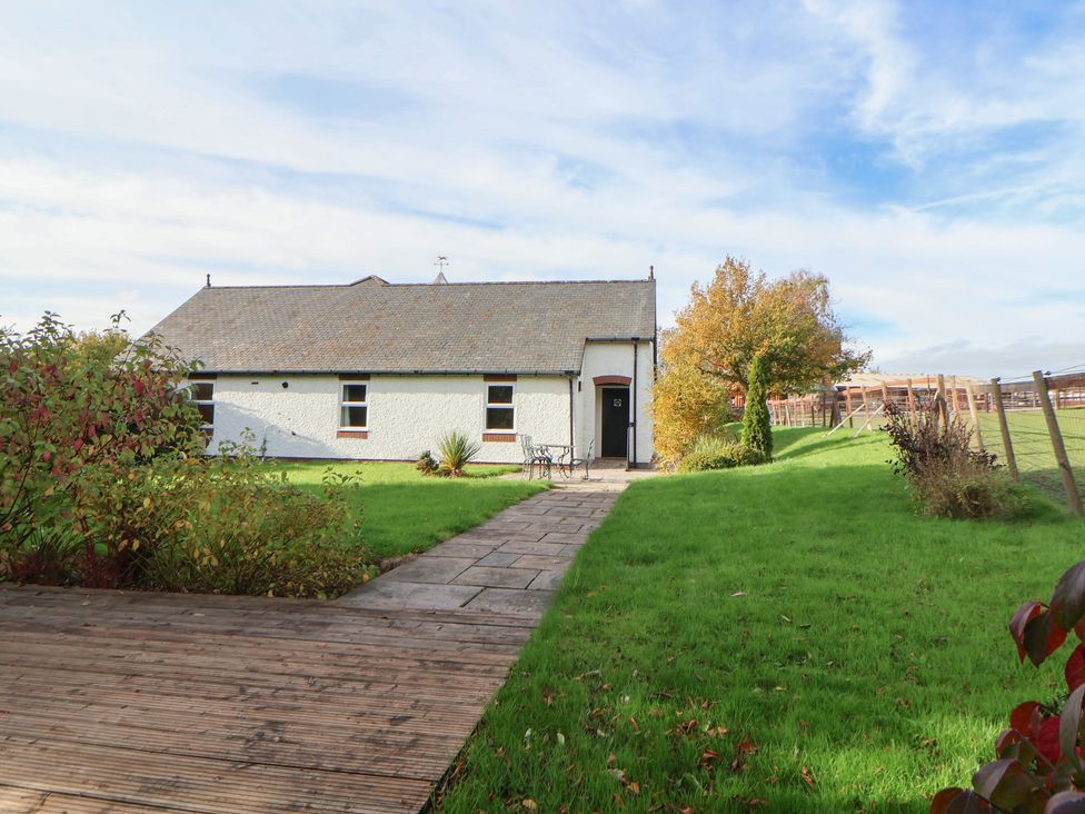 A building with a pathway and grass at Clwyd Special Riding Centre 