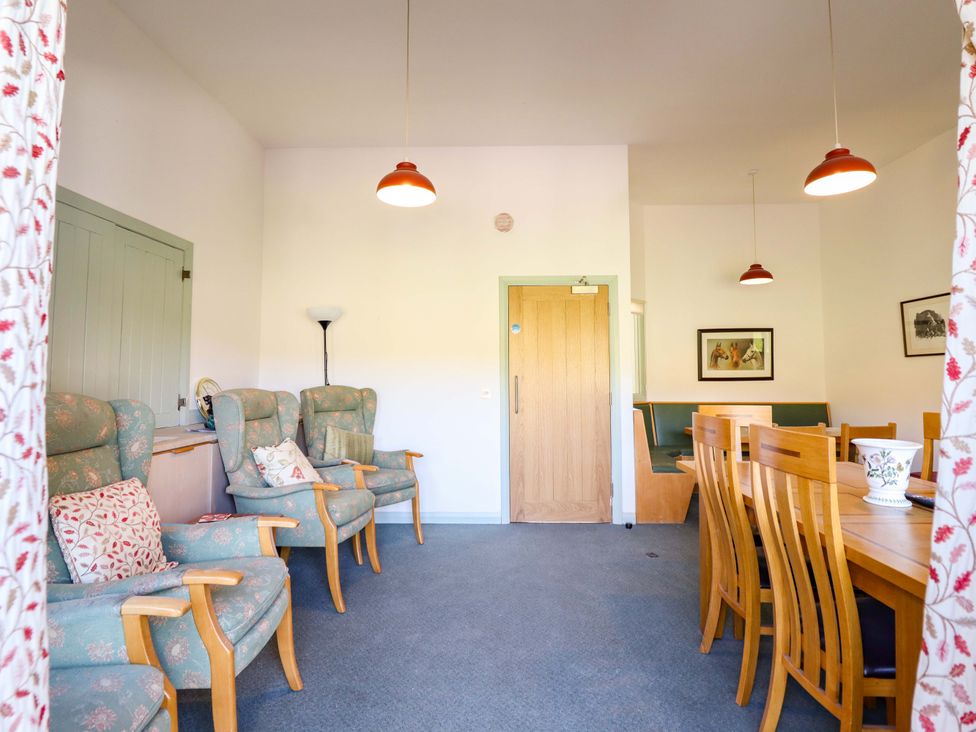 A dining room with chairs and a table at Clwyd Special Riding Centre Llanfynydd