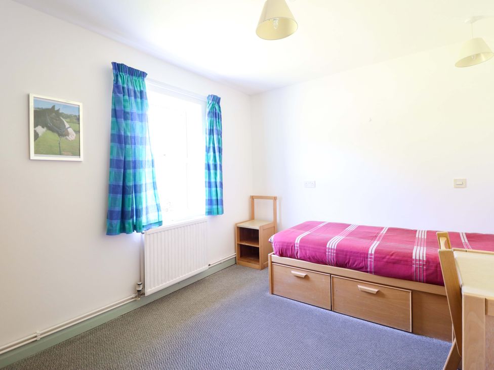 A bedroom with a bed and a window at Clwyd Special Riding Centre in Llanfynydd