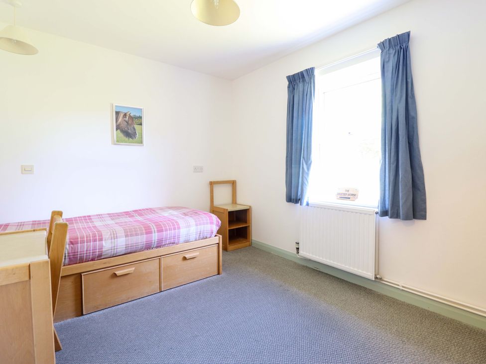 A bedroom with a bed and a window at Clwyd Special Riding Centre in Llanfynydd