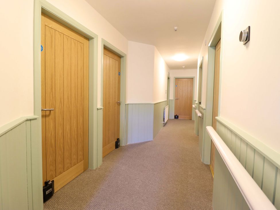 A hallway with doors on either side at Clwyd Special Riding Centre Llanfynydd