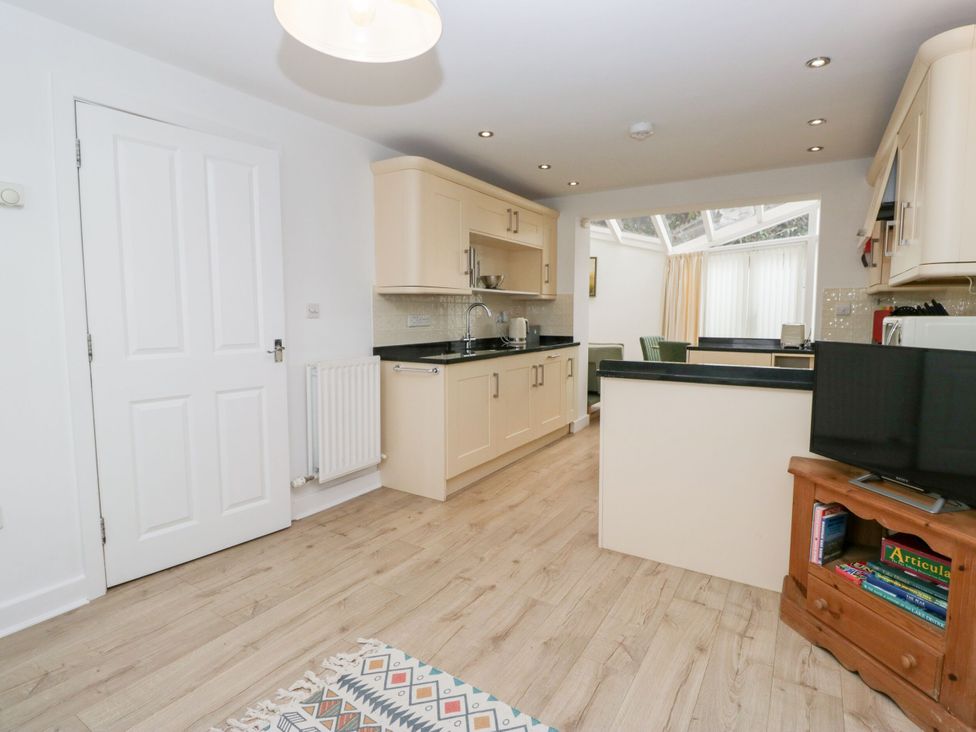 A kitchen with cabinets and a sink at Swirl Howe in Keswick