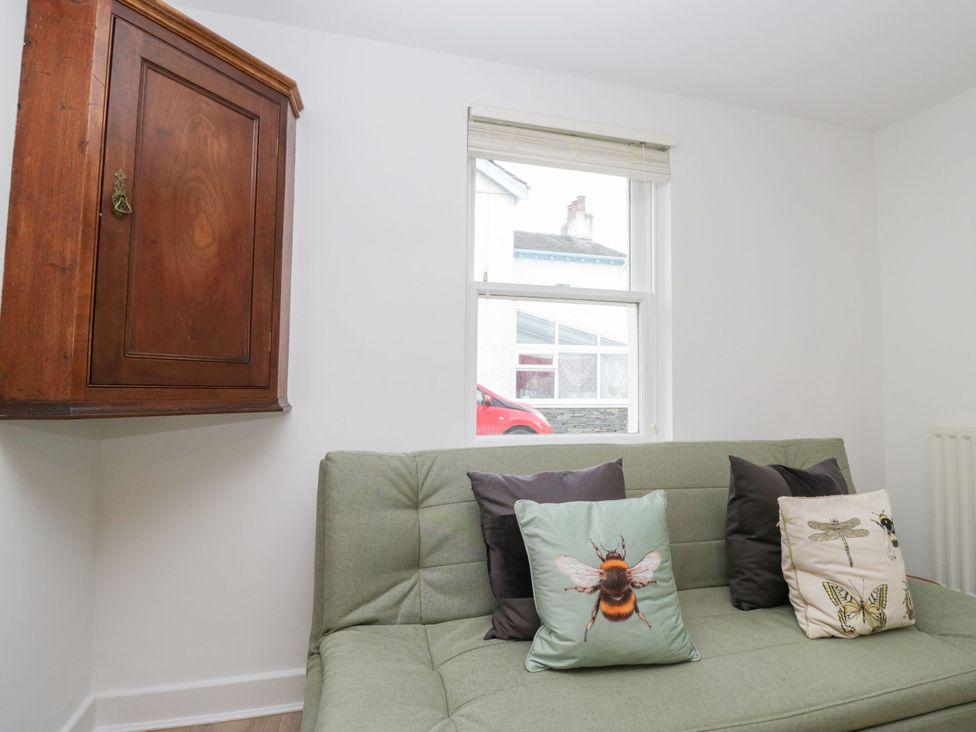 A living room with a sofa and cushions at Swirl Howe in Keswick