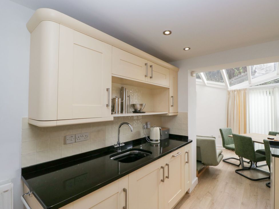 A kitchen with cabinets and a sink at Swirl Howe in Keswick