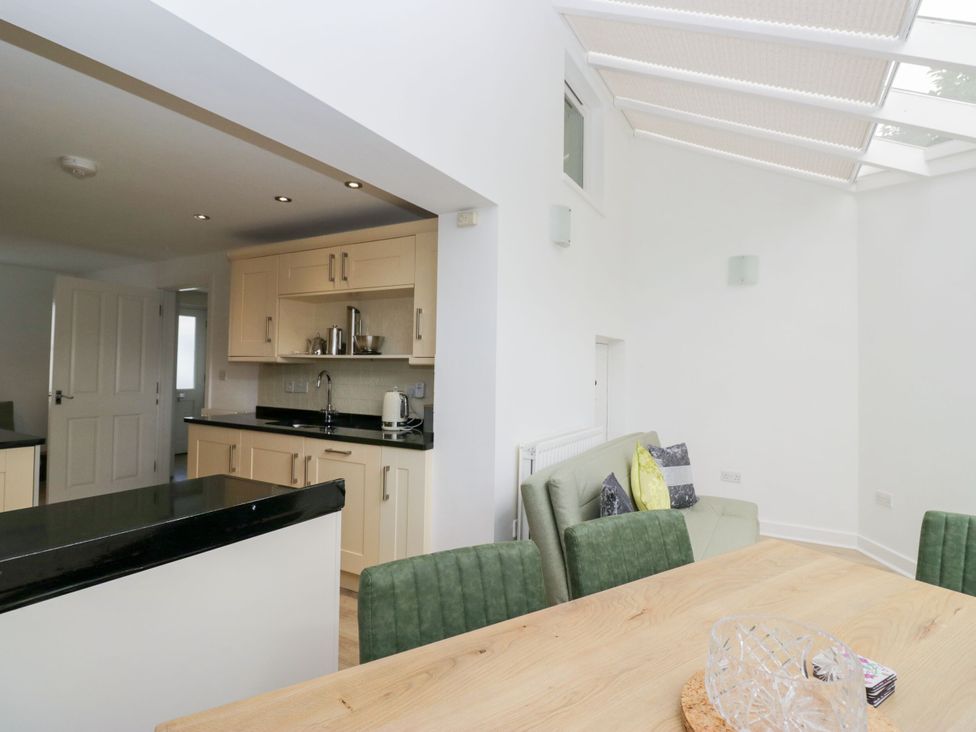 A kitchen with a counter and stools at Swirl Howe in Keswick