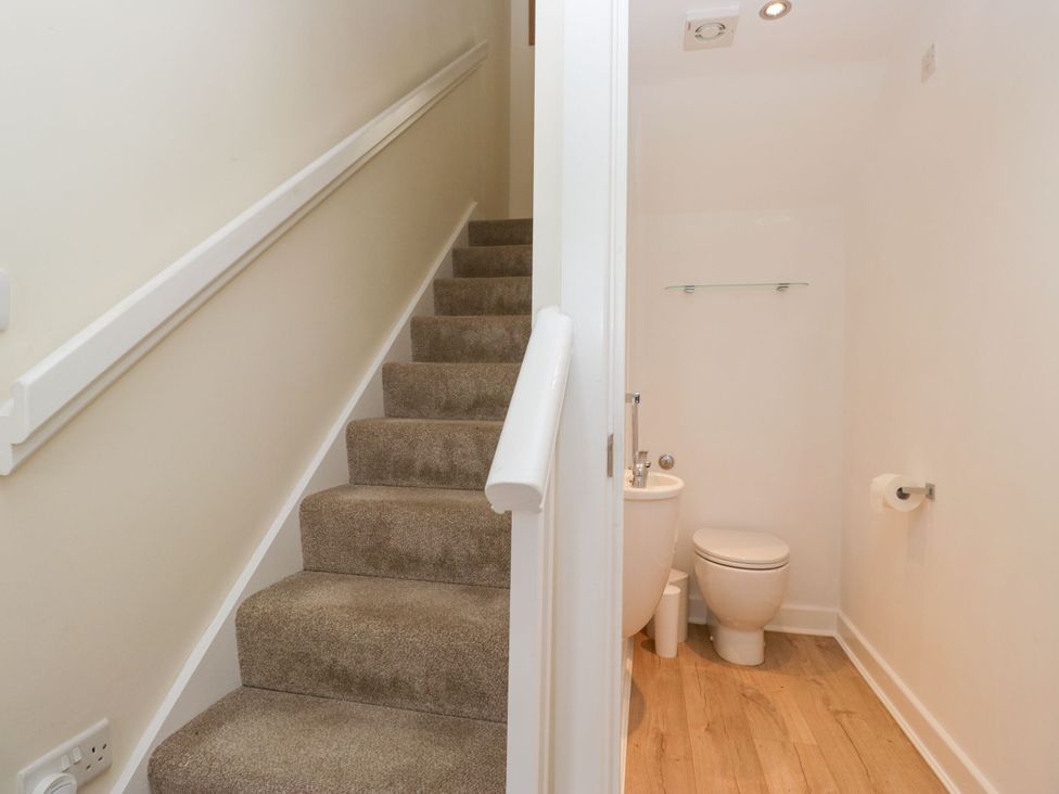 A bathroom with a toilet and sink at Swirl Howe in Keswick
