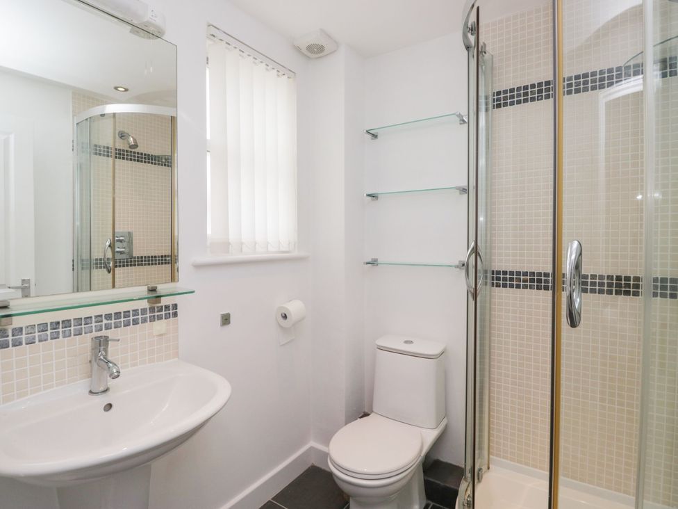 A bathroom with a sink, toilet, and shower at Swirl Howe in Keswick