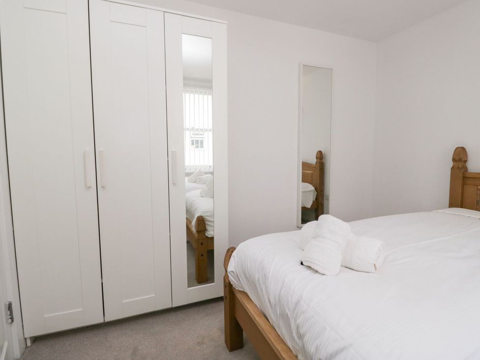 A bedroom with a bed and wardrobe at Swirl Howe in Keswick