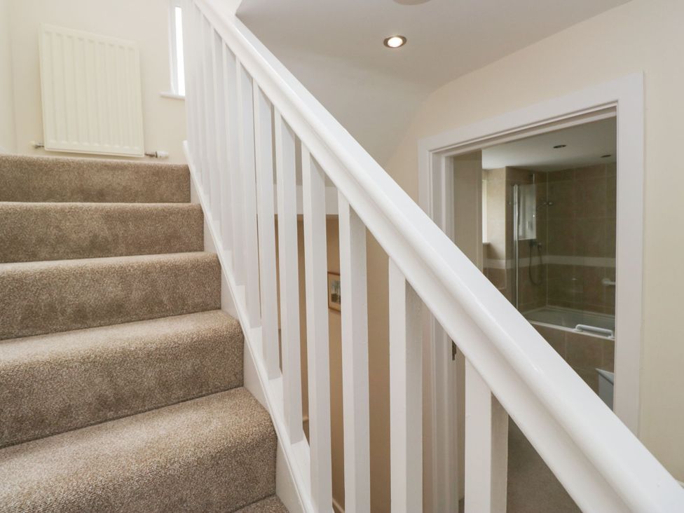 A staircase leading to a bathroom at Swirl Howe in Keswick