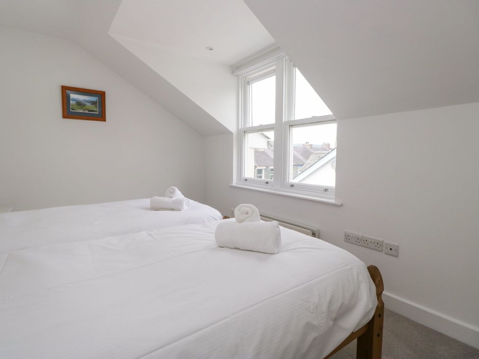 A bedroom with two beds and a window at Swirl Howe in Keswick