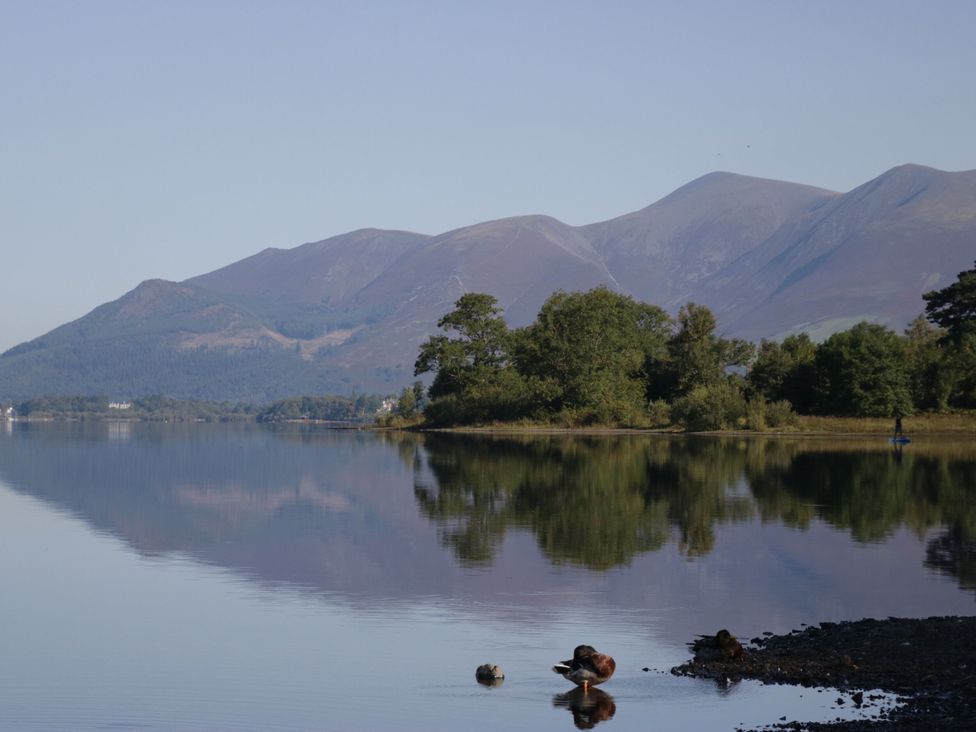 A lake surrounded by mountains and trees at Swirl Howe in Keswick