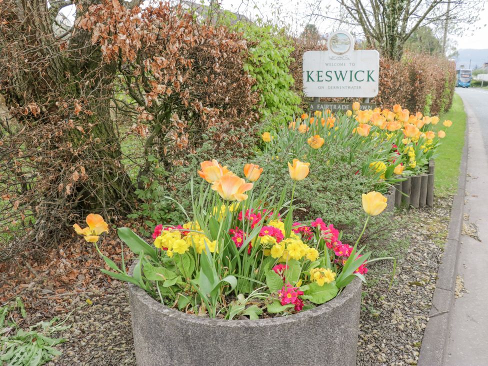 A welcome sign with flowers in planters at Swirl Howe Keswick