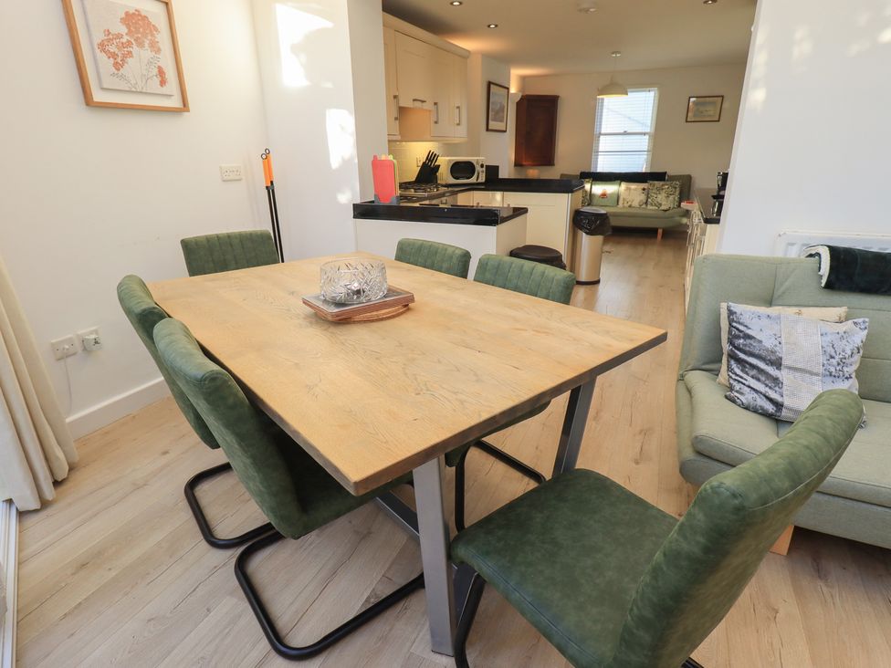 A dining room with a wooden table and chairs at Swirl Howe in Keswick