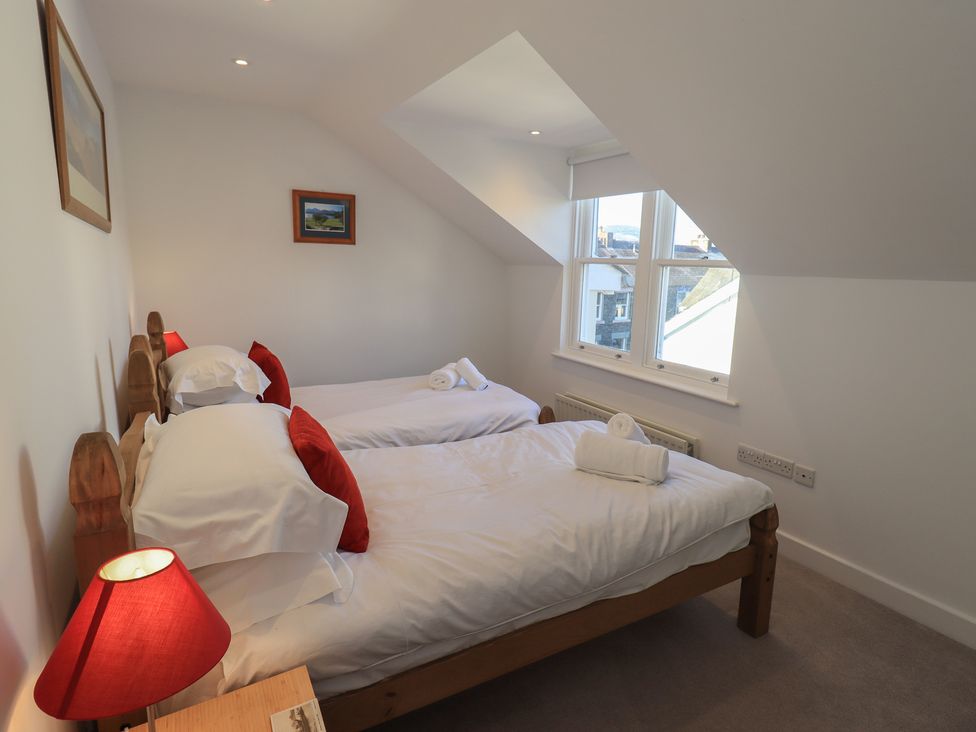 A bedroom with two beds and a window at Swirl Howe in Keswick