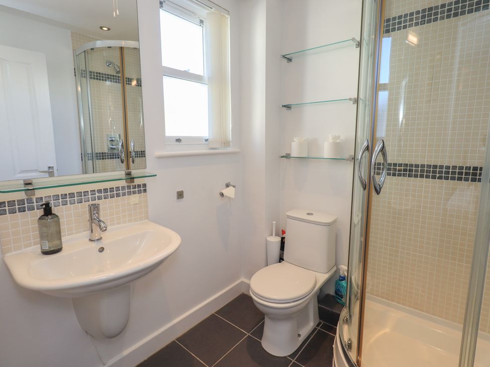 A bathroom with a sink, toilet, and shower at Swirl Howe in Keswick