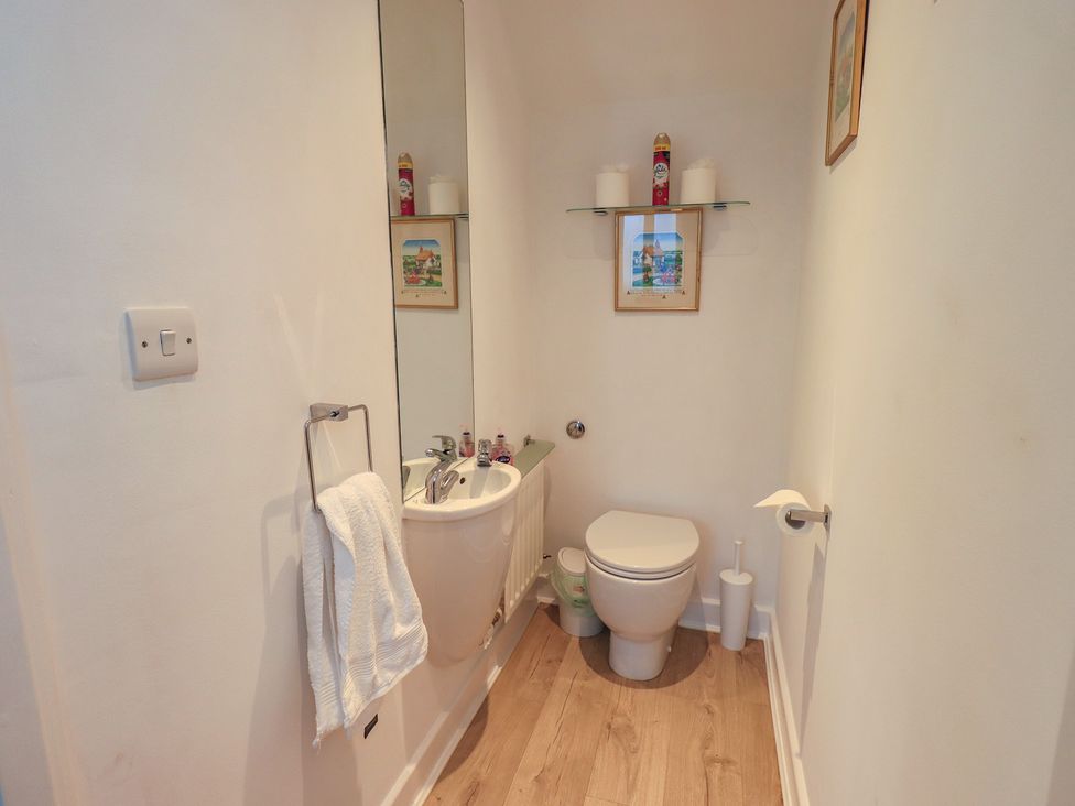 A bathroom with a toilet and sink at Swirl Howe in Keswick
