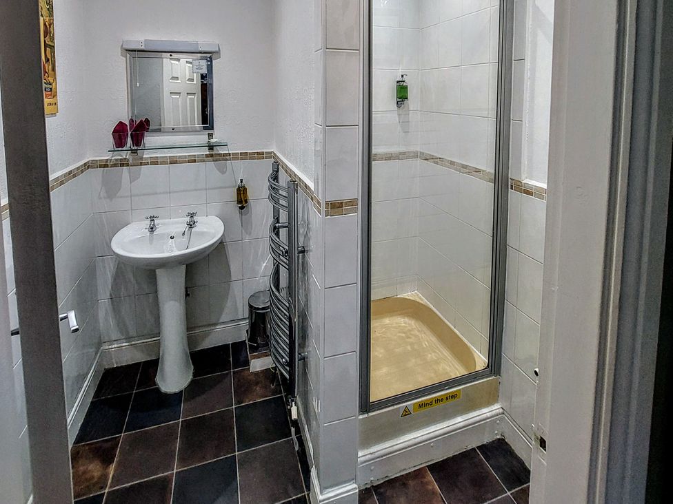 A bathroom with a sink and shower at 1 Park Road Windermere