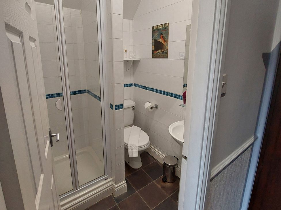 A bathroom with shower, toilet, and sink at 1 Park Road in Windermere