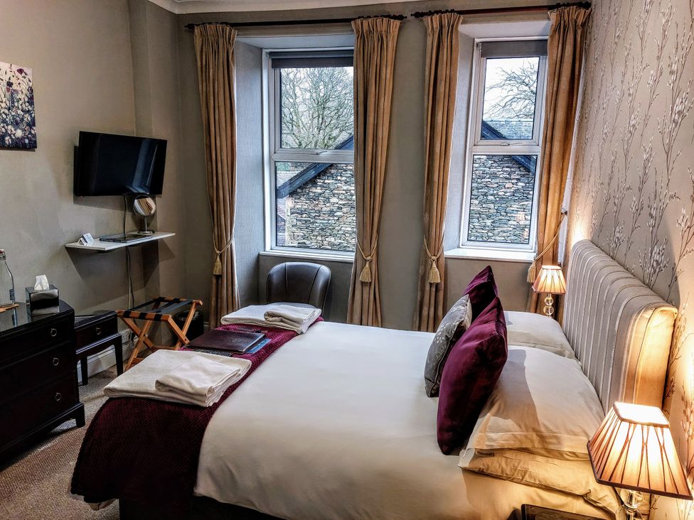 A bedroom with a bed and television at 1 Park Road Windermere