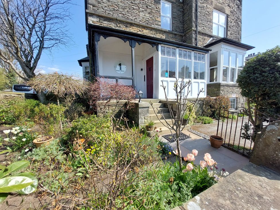 A house with a porch and garden at 1 Park Road Windermere