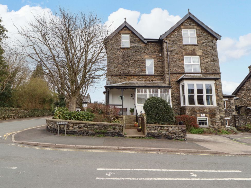 A building with a pathway and trees at 1 Park Road in Windermere