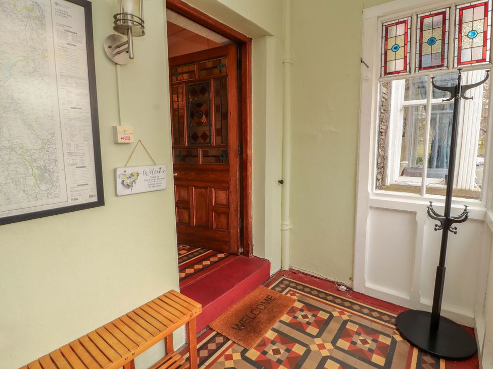 An entrance with a welcome mat and coat stand at 1 Park Road Windermere