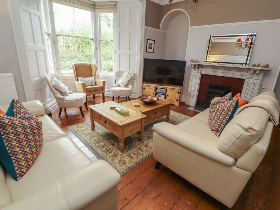 A living room with two armchairs and a coffee table at 1 Park Road in Windermere