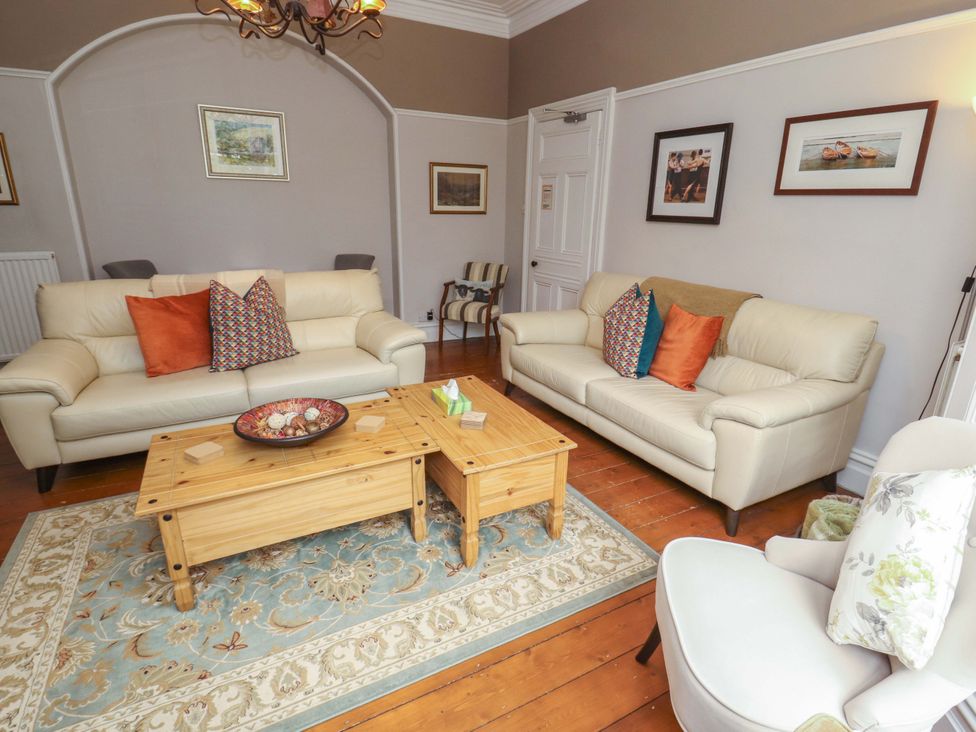 A living room with sofas and a coffee table at 1 Park Road in Windermere